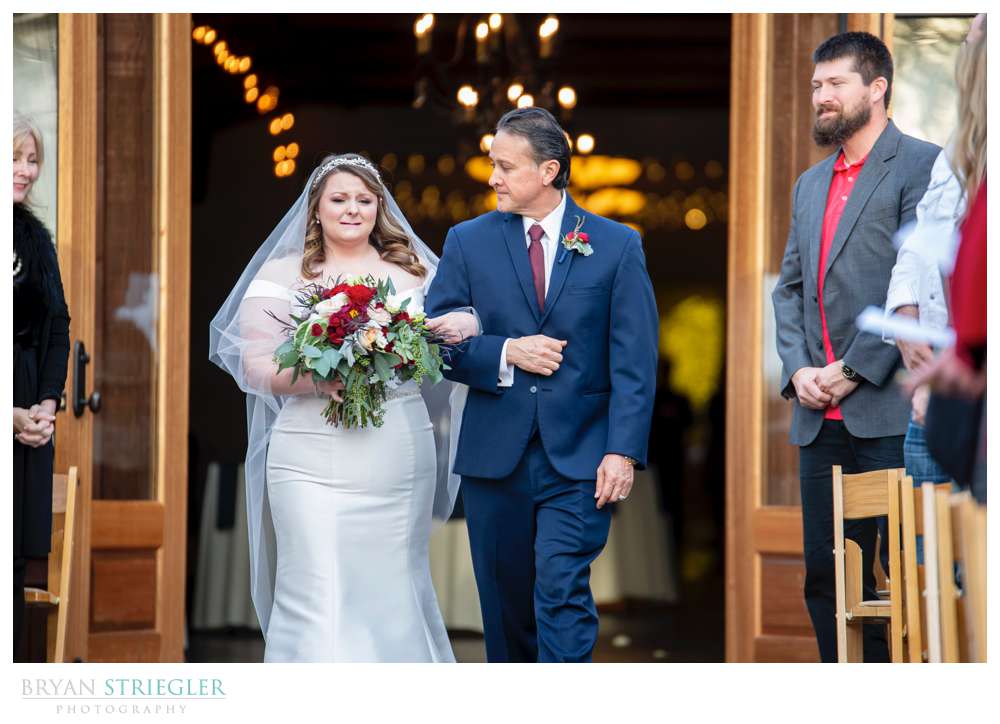 emotional bride walking down the aisle